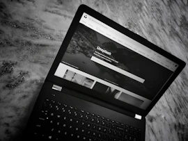 A stylish desktop and mobile view of a black and gold themed website homepage.