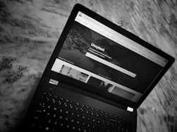A snapshot of a brand’s homepage on a laptop screen, linking visitors to more details