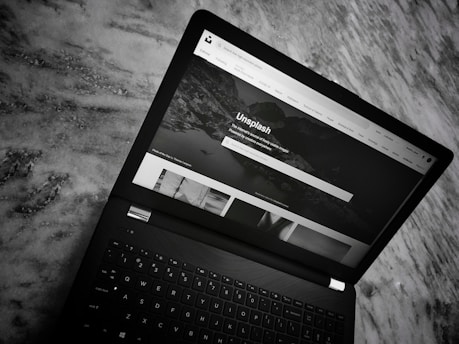 A close-up shot of a sleek laptop displaying a personal portfolio website with the name 'neptale s roa iii' prominently featured.