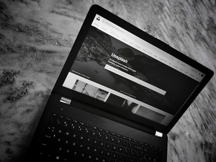 A sleek laptop displaying the Wanas Digital marketplace homepage in dark mode.