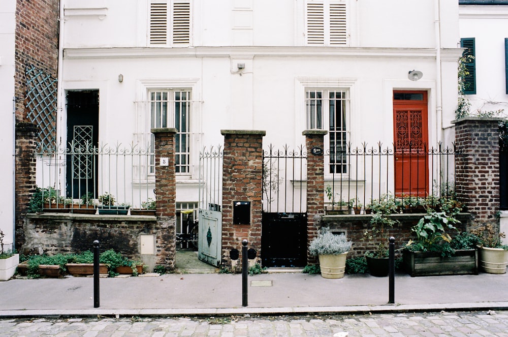 white concrete building with green plants