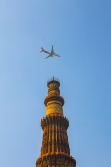 white airplane flying in the sky during daytime