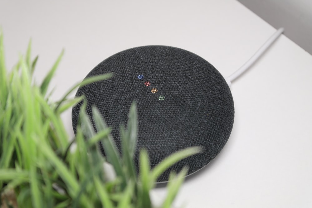 black round portable speaker on white table