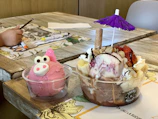 Surf-shaped spoons arranged artistically beside tropical fruits and bowls of ice cream