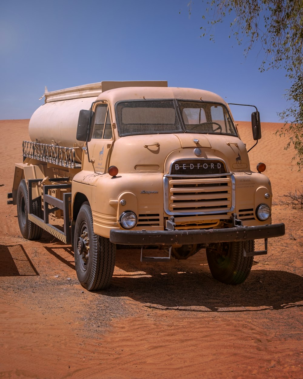 yellow truck on brown dirt road during daytime