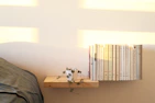 Minimalist bookshelf filled with books and plants in a bright room