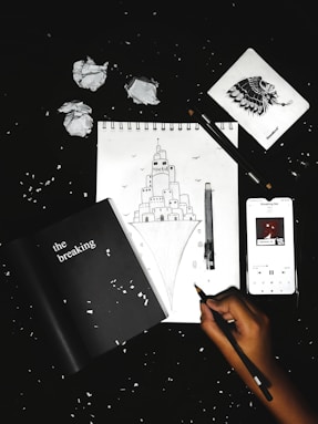 person holding black pen writing on white paper