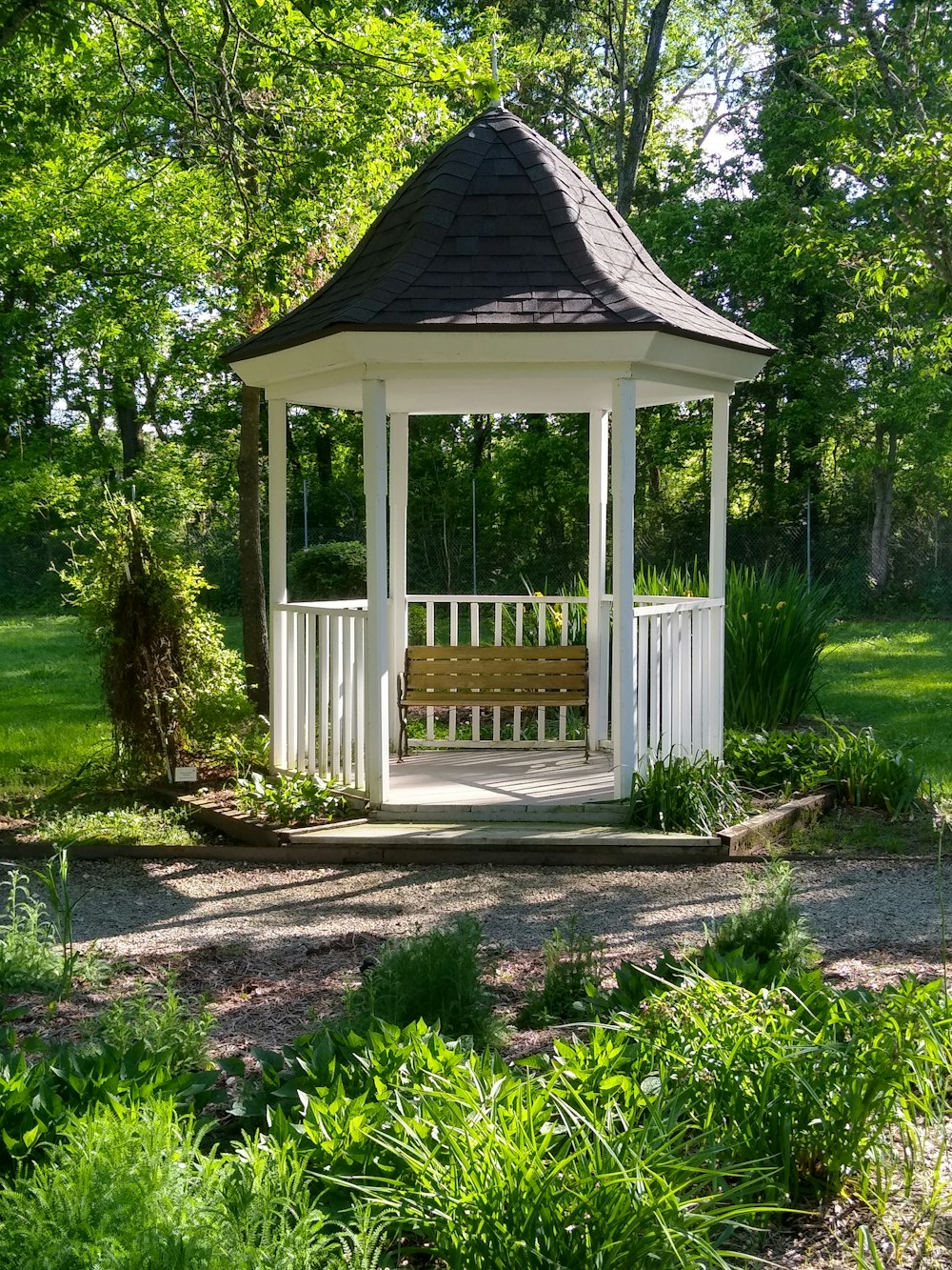 white wooden house near green trees during daytime