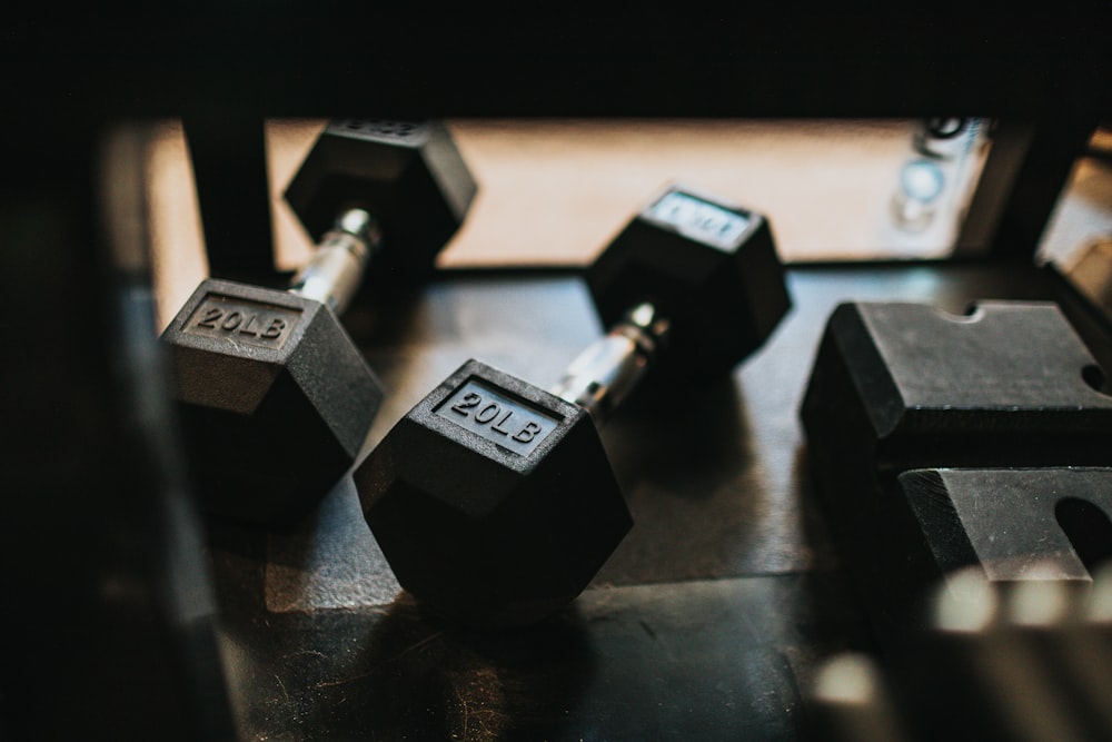 black and silver dumbbells on black table
