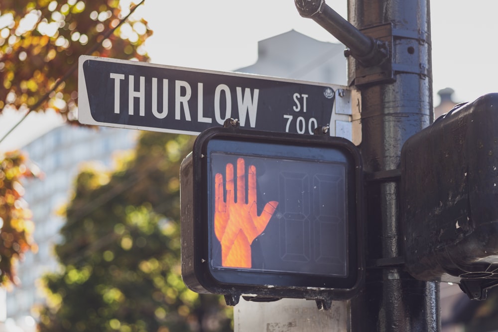 a close up of a street sign with trees in the background