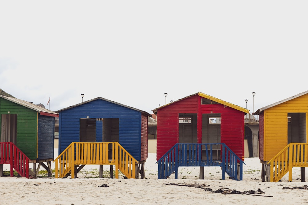 blue and brown wooden house on white sand during daytime