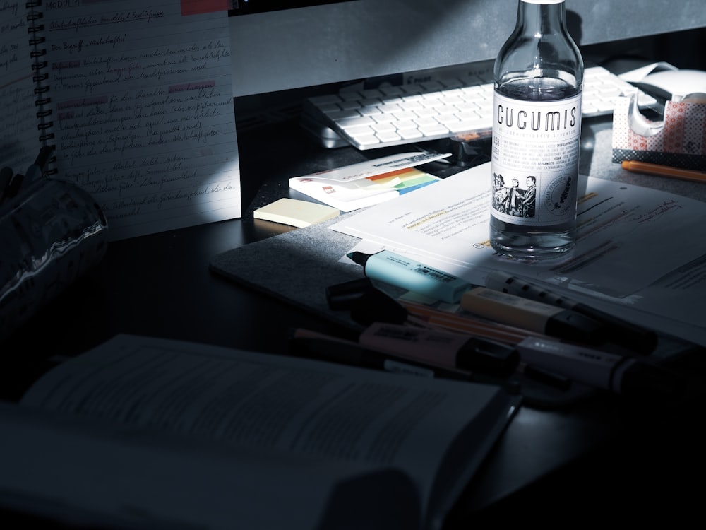 clear glass bottle on black table