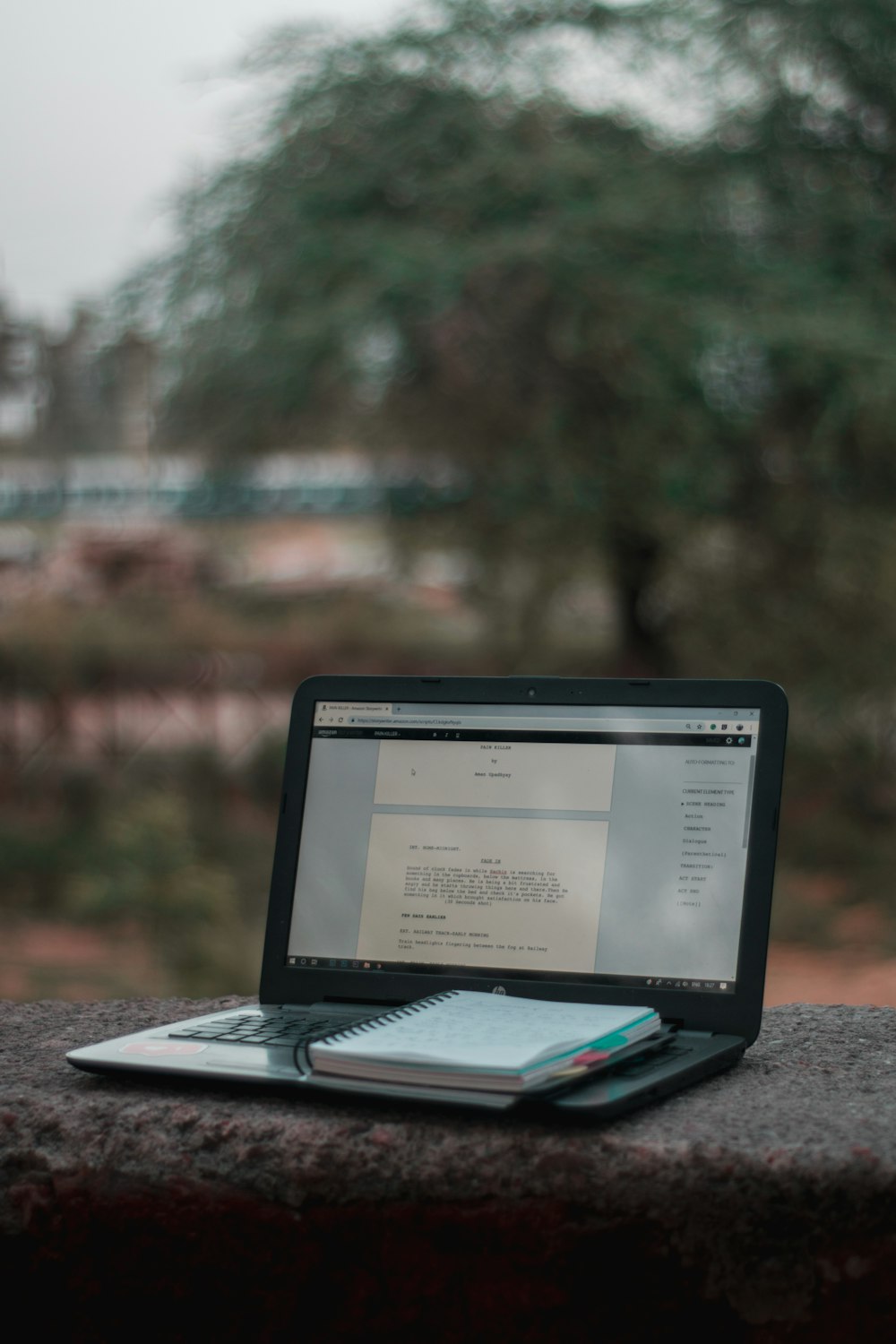 black laptop computer on brown wooden table