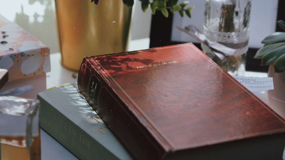 red hardbound book on white table