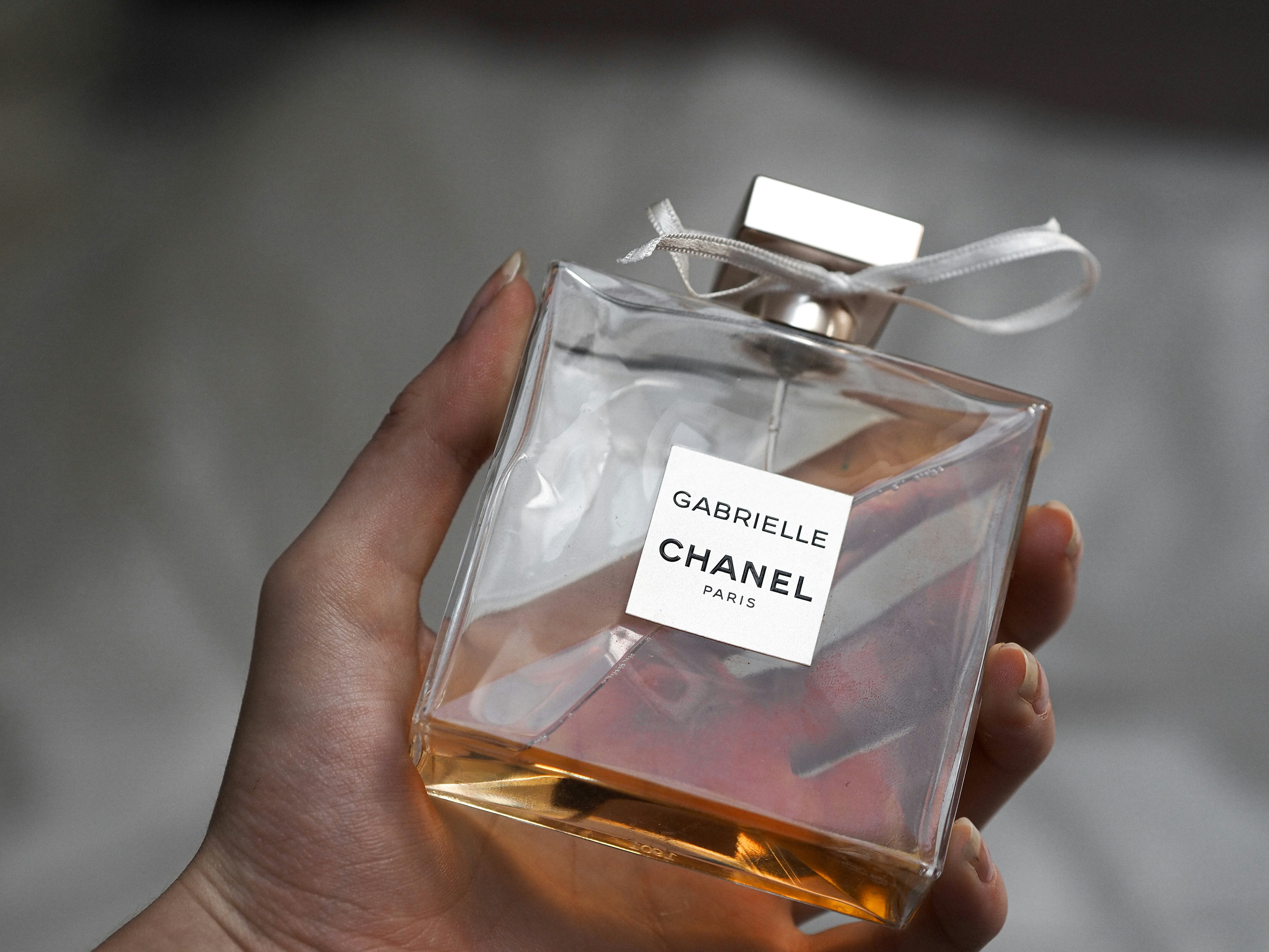 person holding calvin klein one perfume bottle
