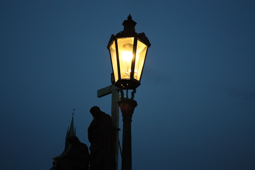 black street light turned on during night time