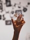 person holding clear glass perfume bottle