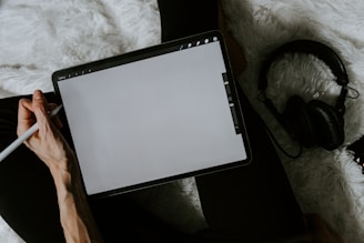 black tablet computer on white textile
