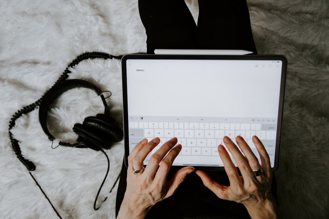 person using white laptop computer