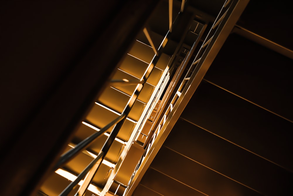 brown wooden stairs with white metal railings