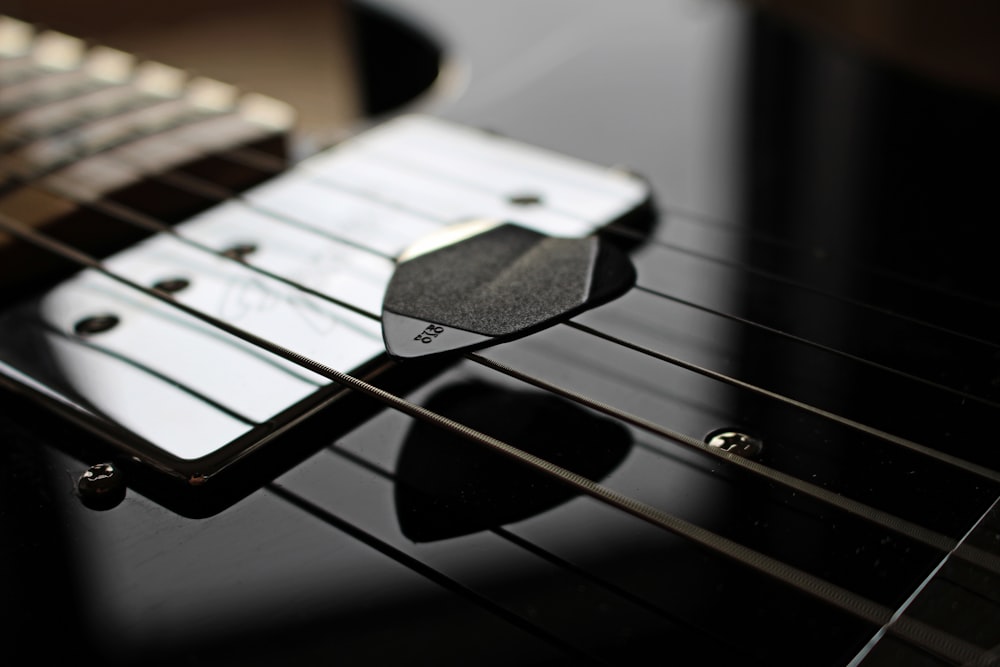 black guitar pick on guitar