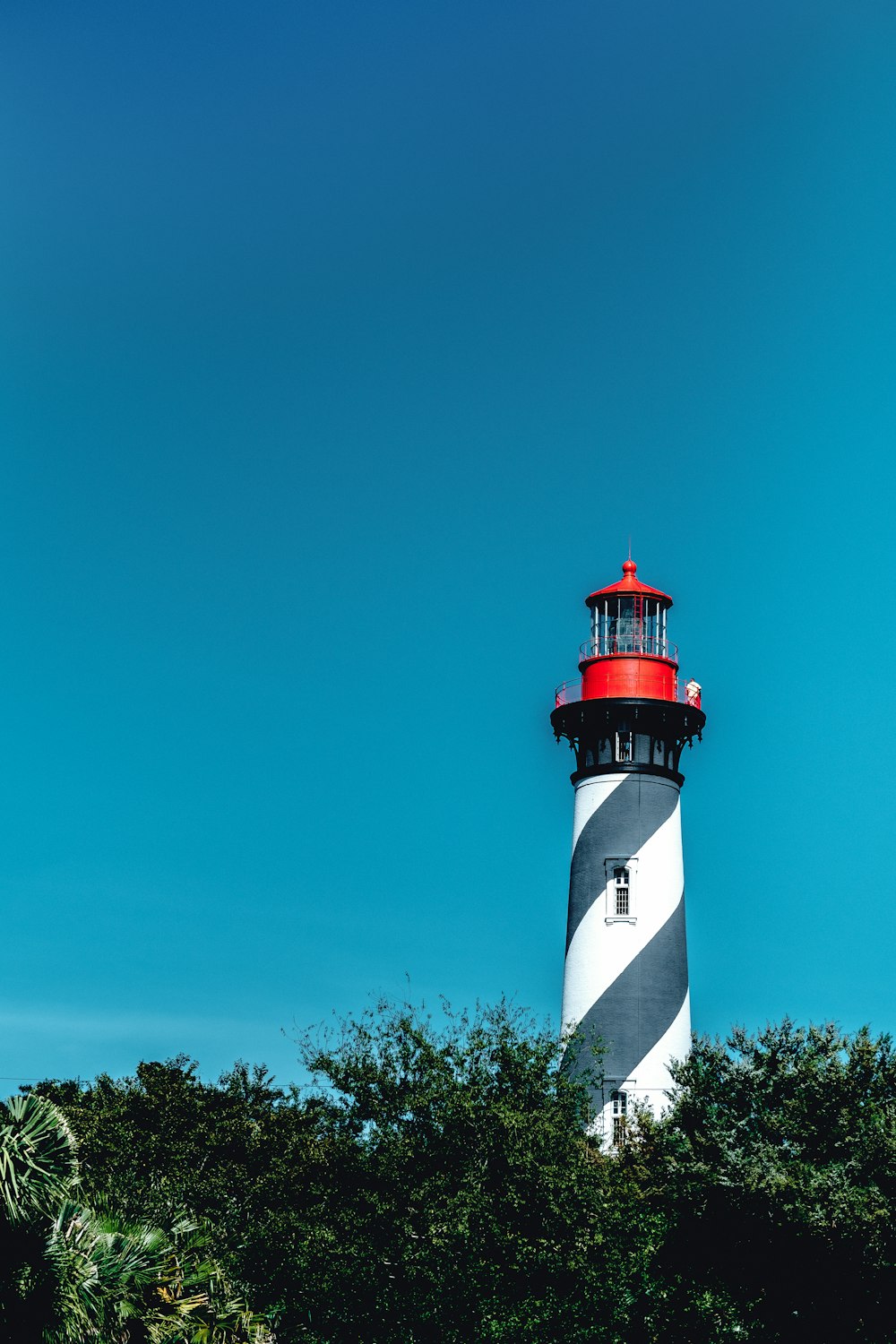 white and red lighthouse under blue sky during daytime