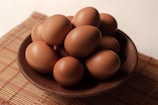 A close-up of healthy, organic eggs on a wooden table.