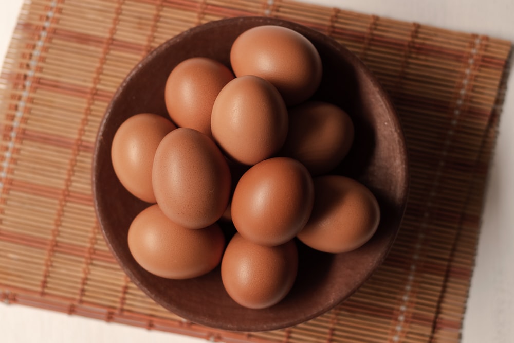 brown egg on brown wooden bowl