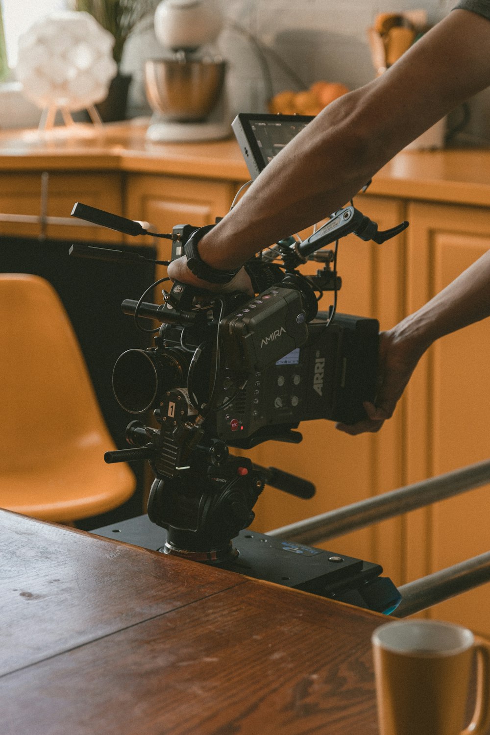 black video camera on brown wooden table