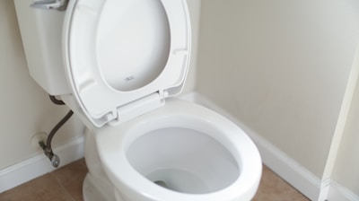white ceramic toilet bowl with cover