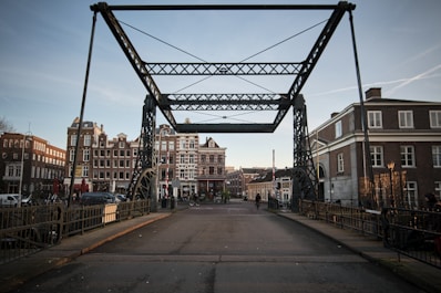 brown concrete building near bridge during daytime