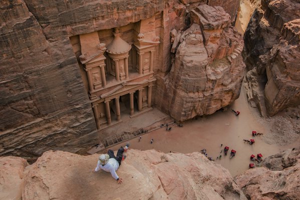 People walking on brown rocky mountain during daytime — Petra, Jordan