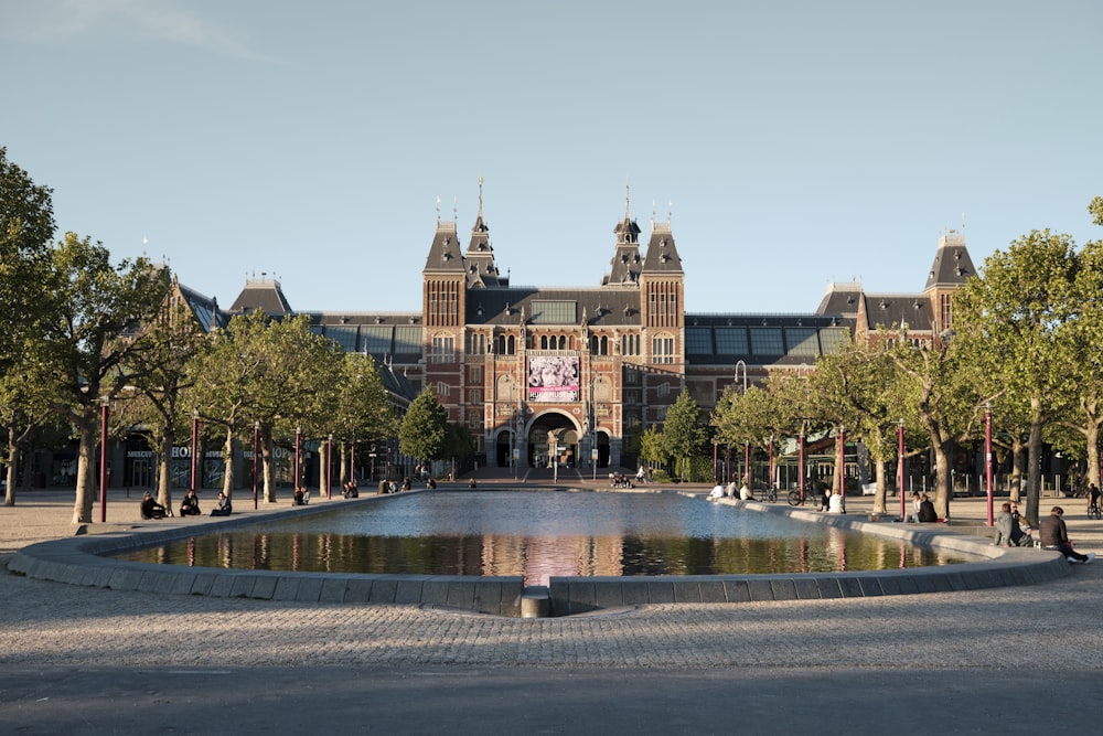 people walking on park near brown building during daytime