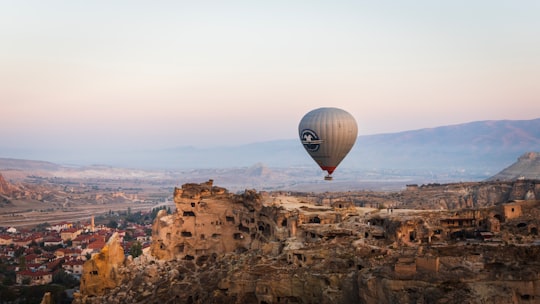 hot air balloon on top of brown rock formation during daytime in Göreme Turkey