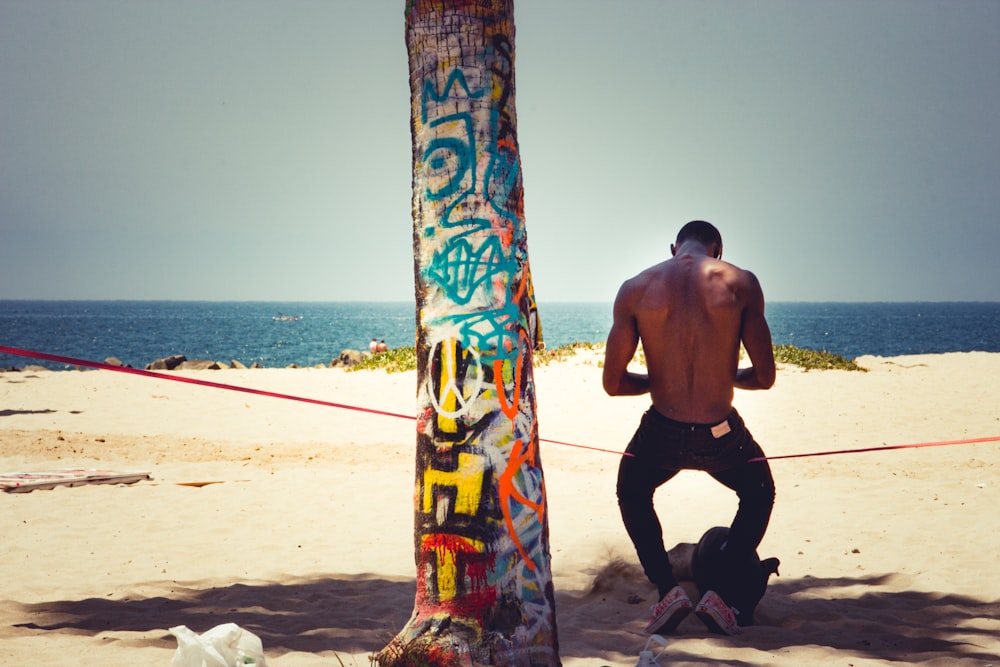 man in black shorts standing on beach during daytime