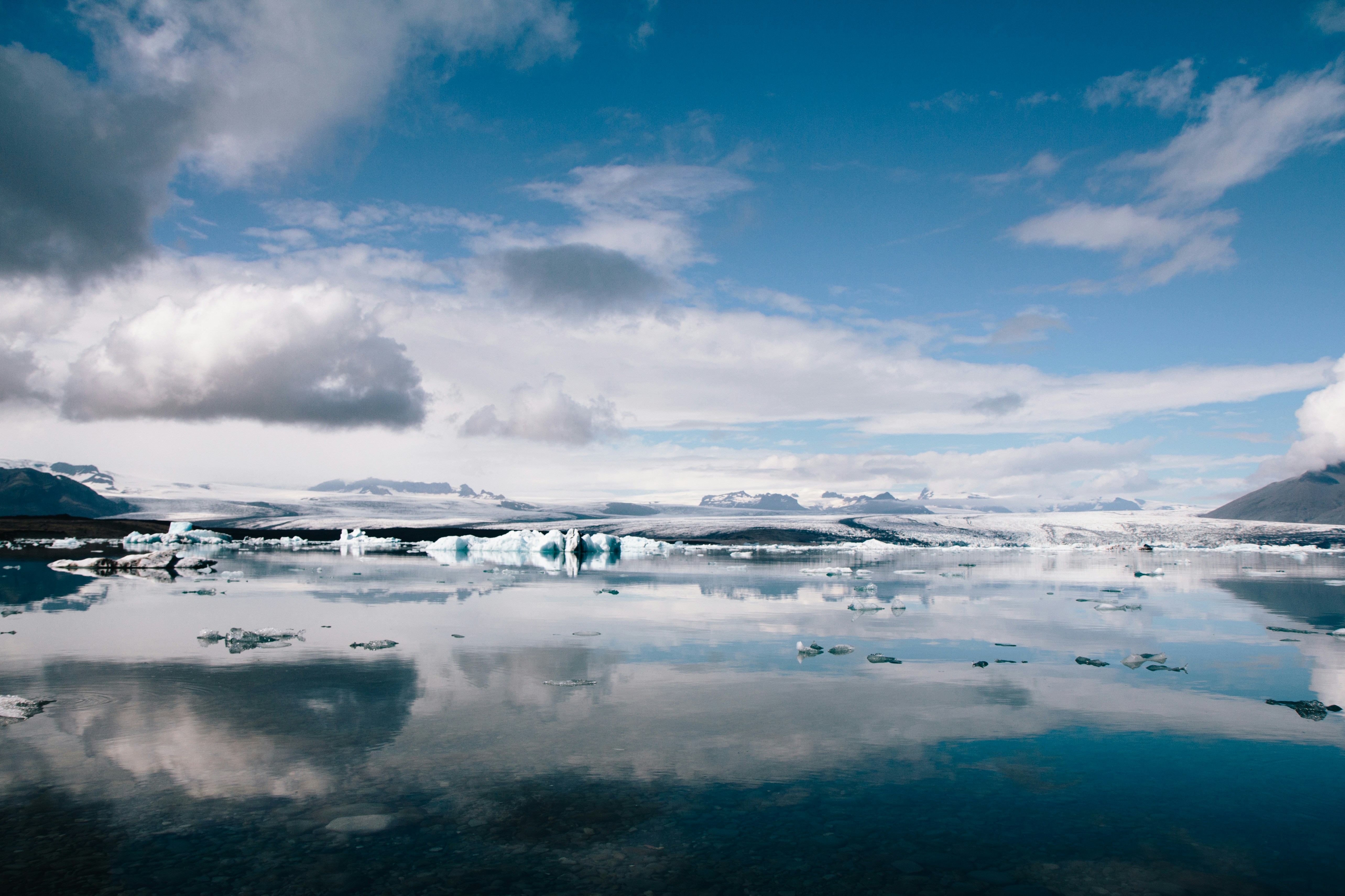white clouds over snow covered field during daytime, Jökulsárlón, Iceland