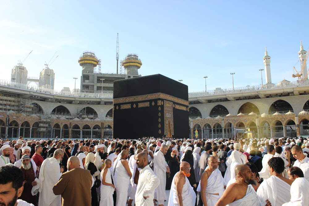 people standing in front of white concrete building during daytime