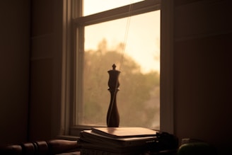 A serene study nook bathed in soft natural light with open books and a simple wooden table.