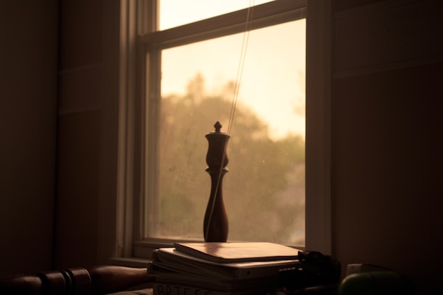 A serene study nook bathed in soft natural light with open books and a simple wooden table.