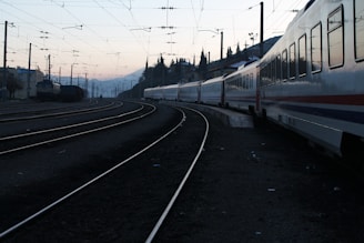 red and white train on rail road during daytime