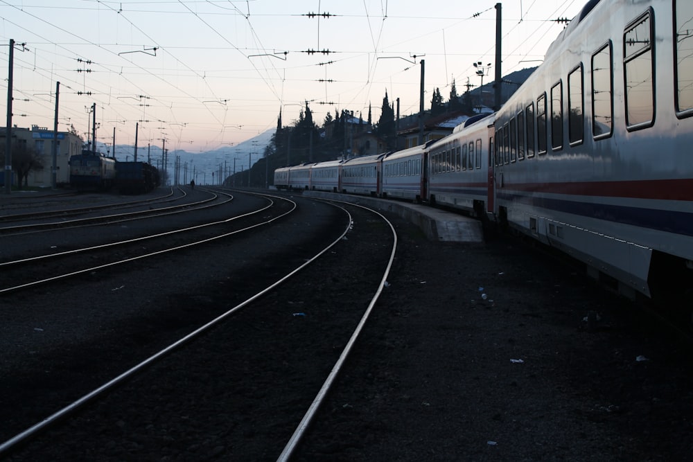 red and white train on rail road during daytime