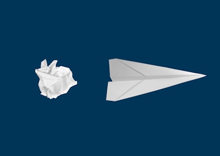 white paper plane on white background