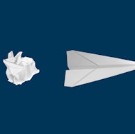 white paper plane on white background
