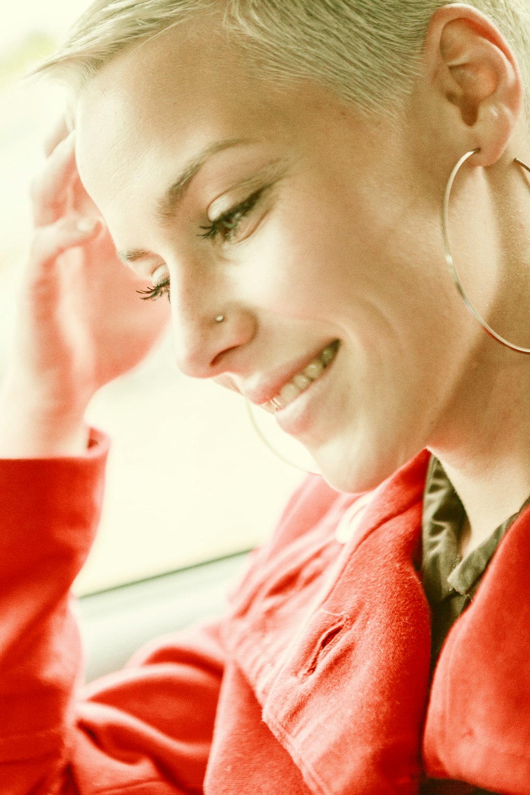 woman in red blazer wearing silver hoop earrings