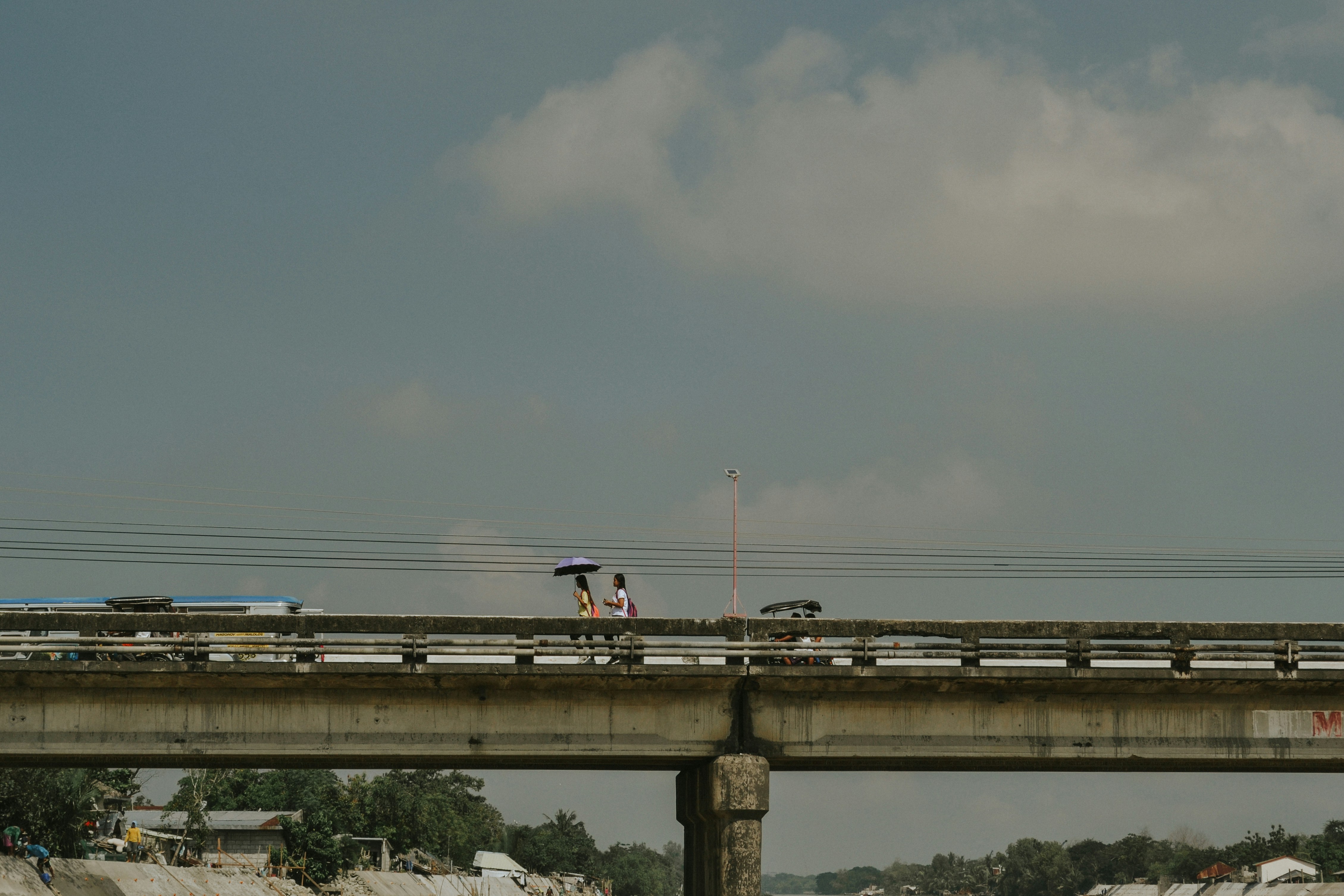 white and blue train on rail under gray sky