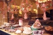 An inviting bakery display featuring a variety of cakes with warm lighting.