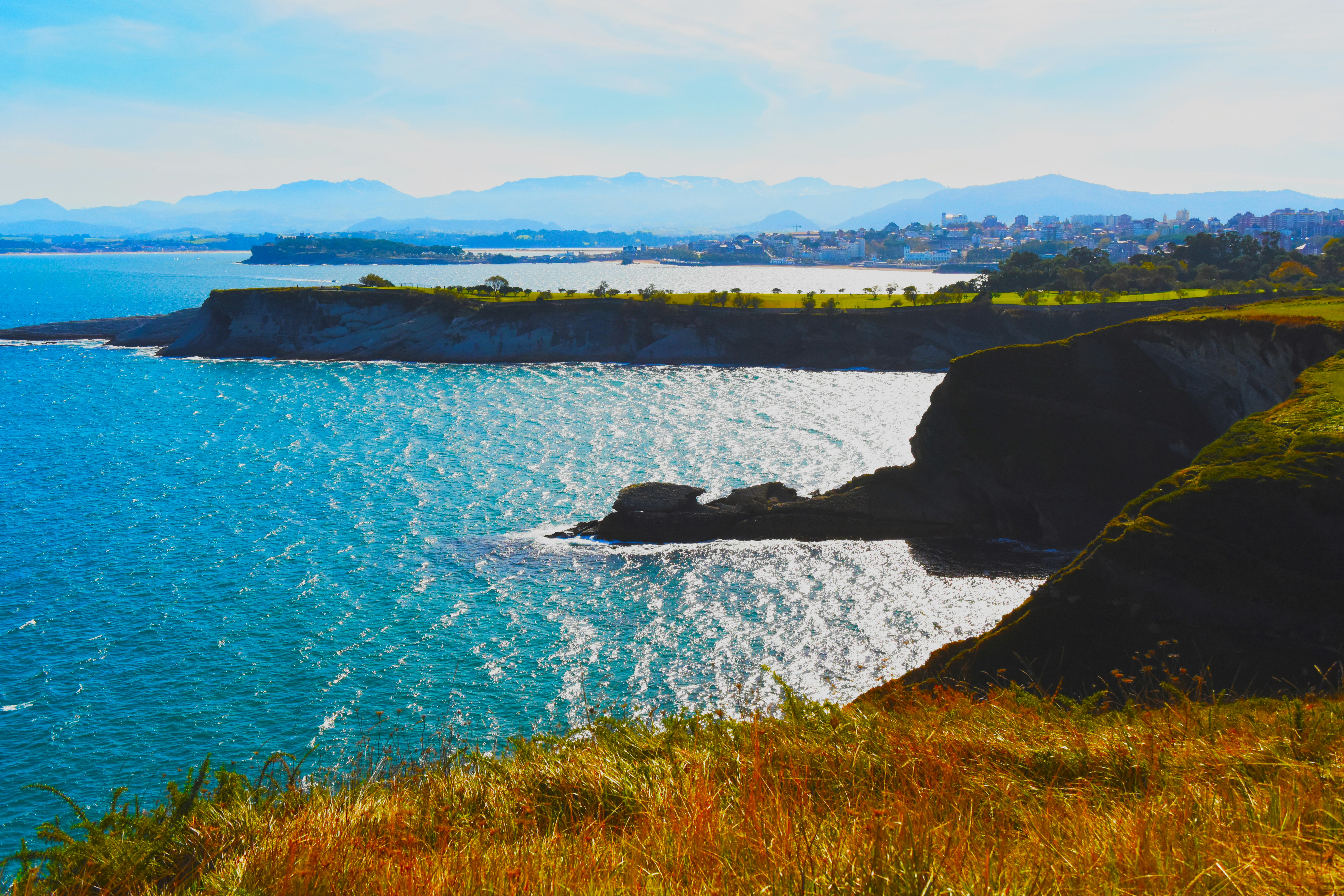 green grass field near body of water during daytime cabo verde teams background