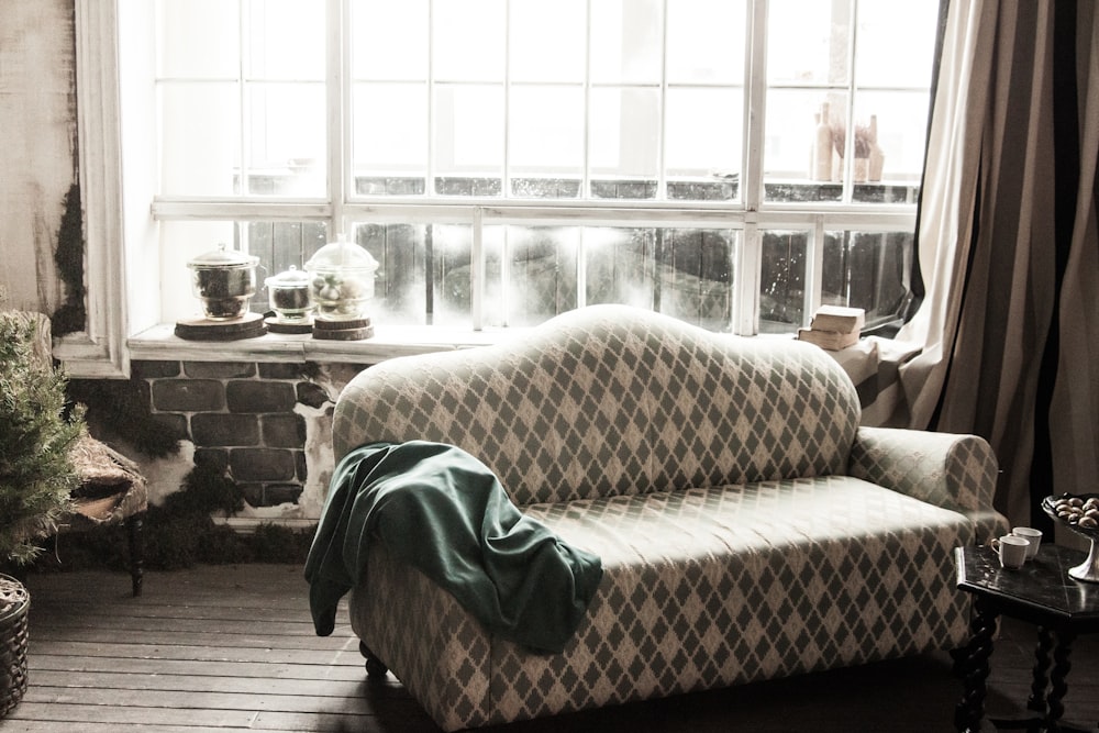 green textile on brown and white sofa