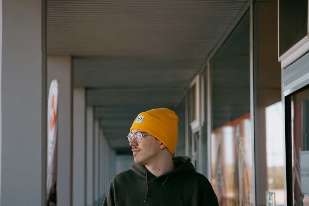 man in yellow knit cap and green hoodie