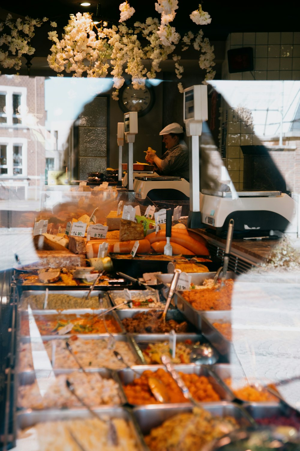 man in black jacket sitting on black chair in front of food display counter